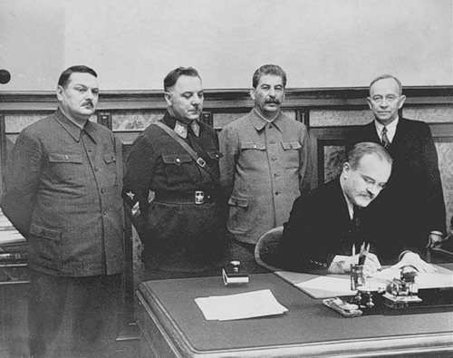 Фото: Вячеслав Молотов подписывает договор о взаимопомощи и дружбе с правительством Куусинена.